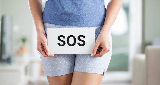 woman holding an SOS sign because she has bacterial vaginosis